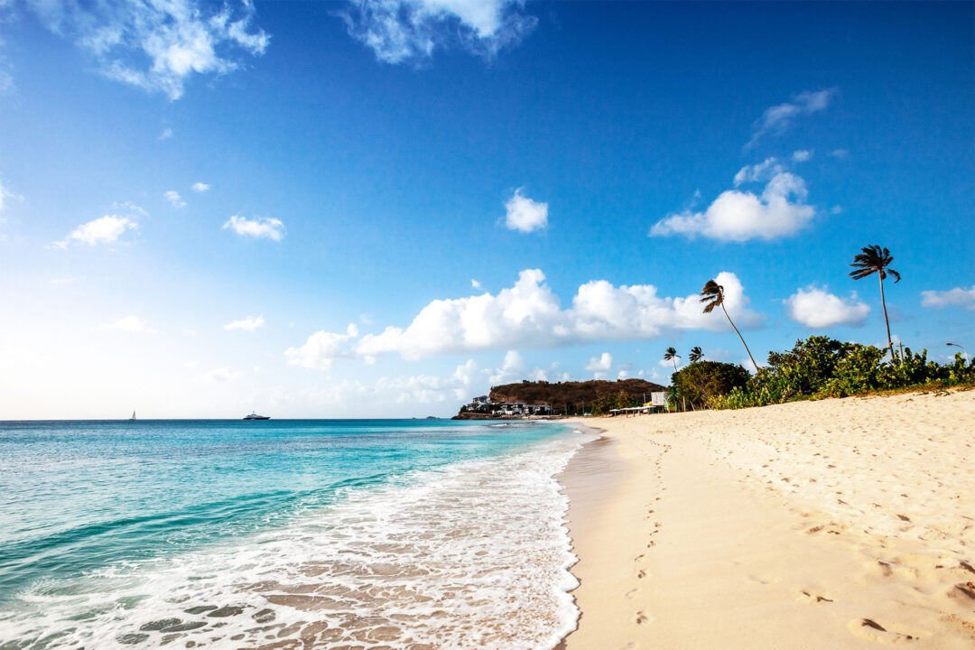 Serene beach with clear blue waters in the Carribeans where you can get a citizenship by investment.