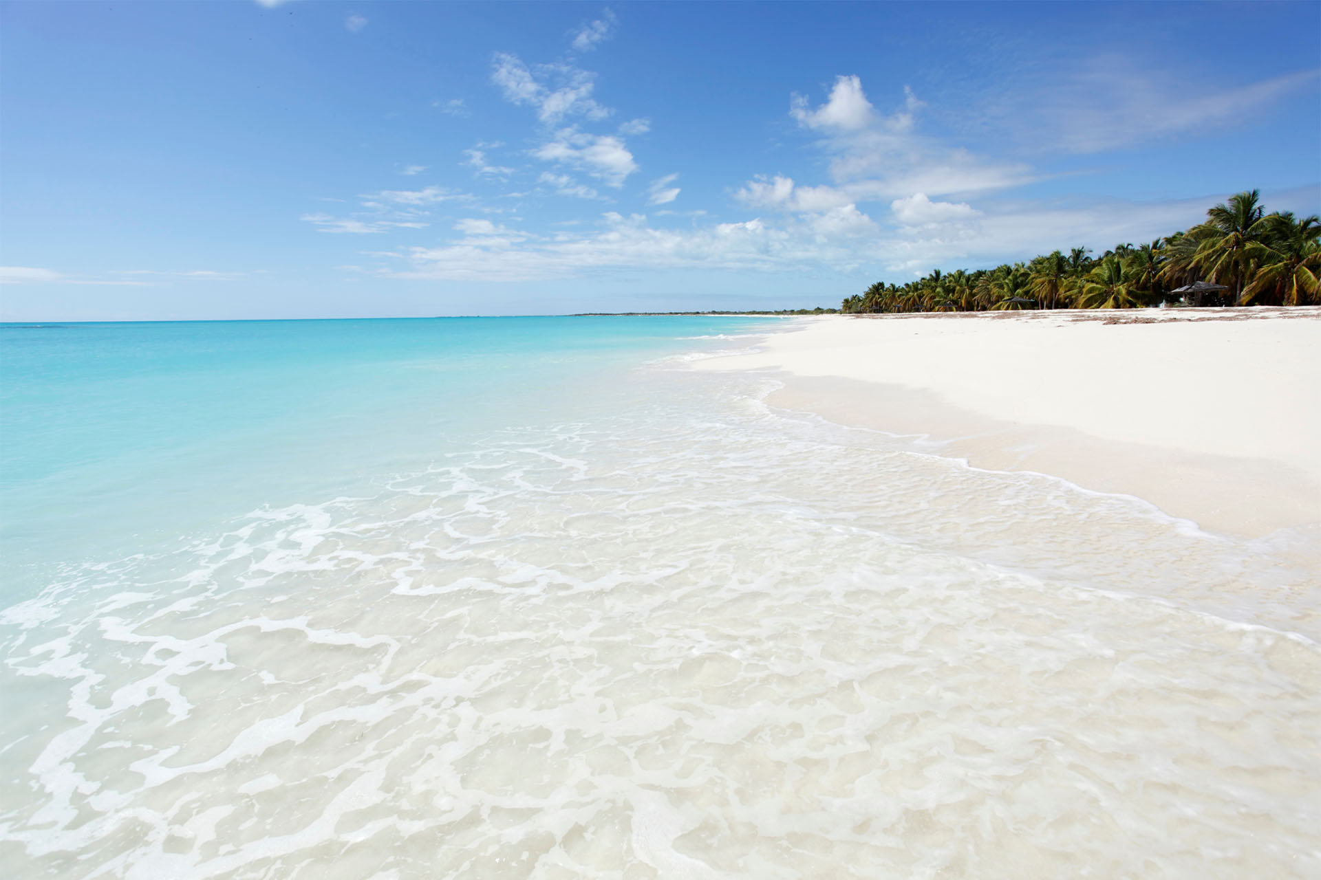 Pristine beach with turquoise waters. Gain citizenship by investment in the Carribeans with Prism.