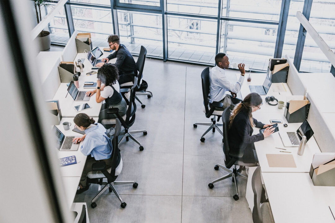 Modern office with focused professionals working. Prism support your company incorporation.