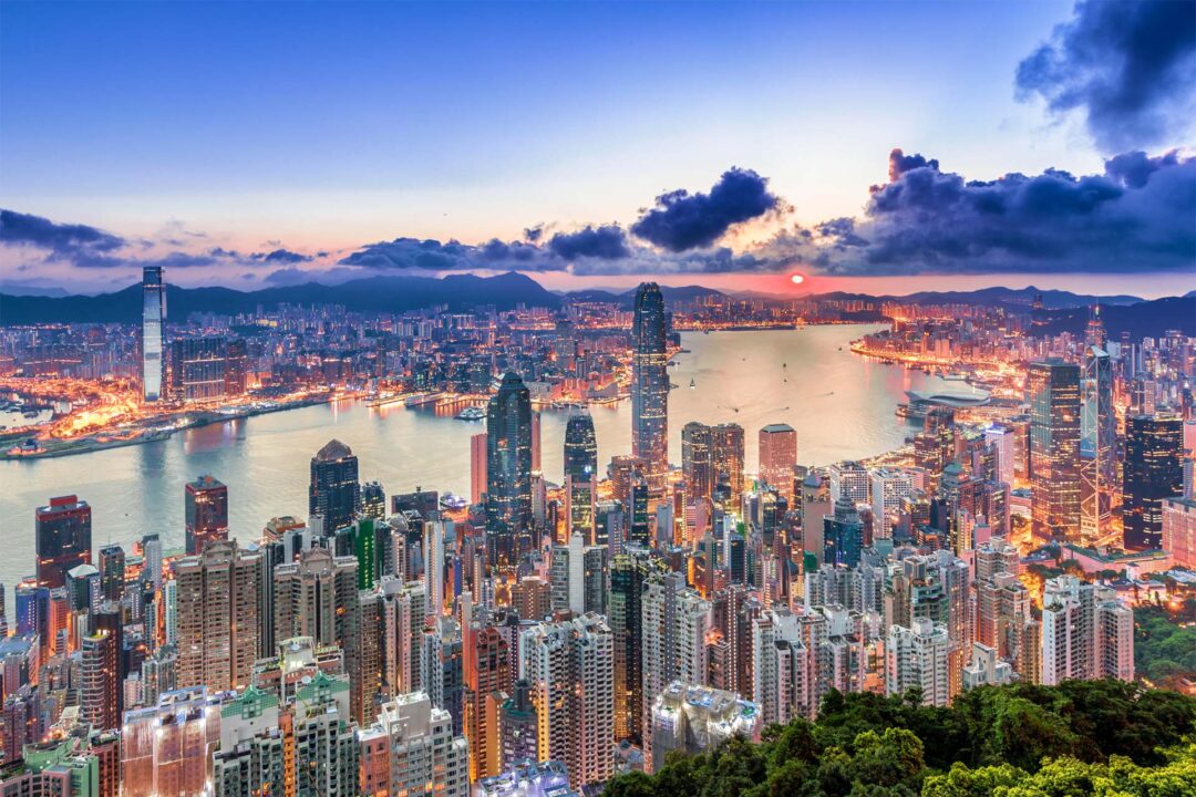 Vibrant city skyline at sunset in Hong Kong. Get in touch with Prism for visas, immigration and company incorporation.