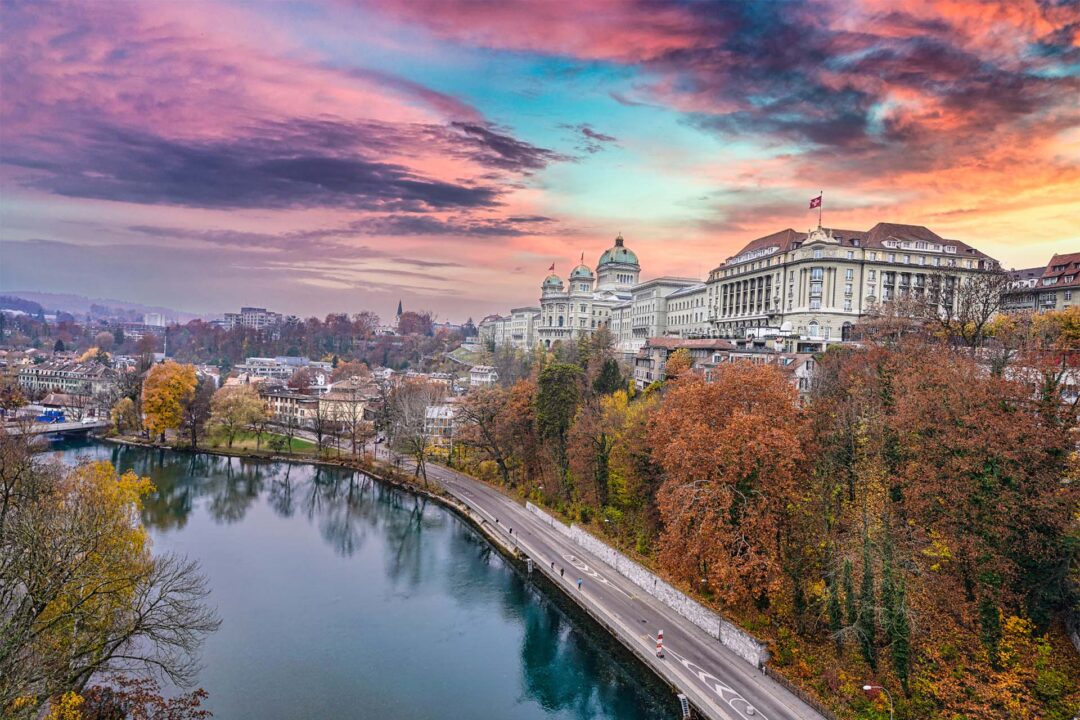 Autumn scenery by a serene river in Switzerland, a great country to live and work.