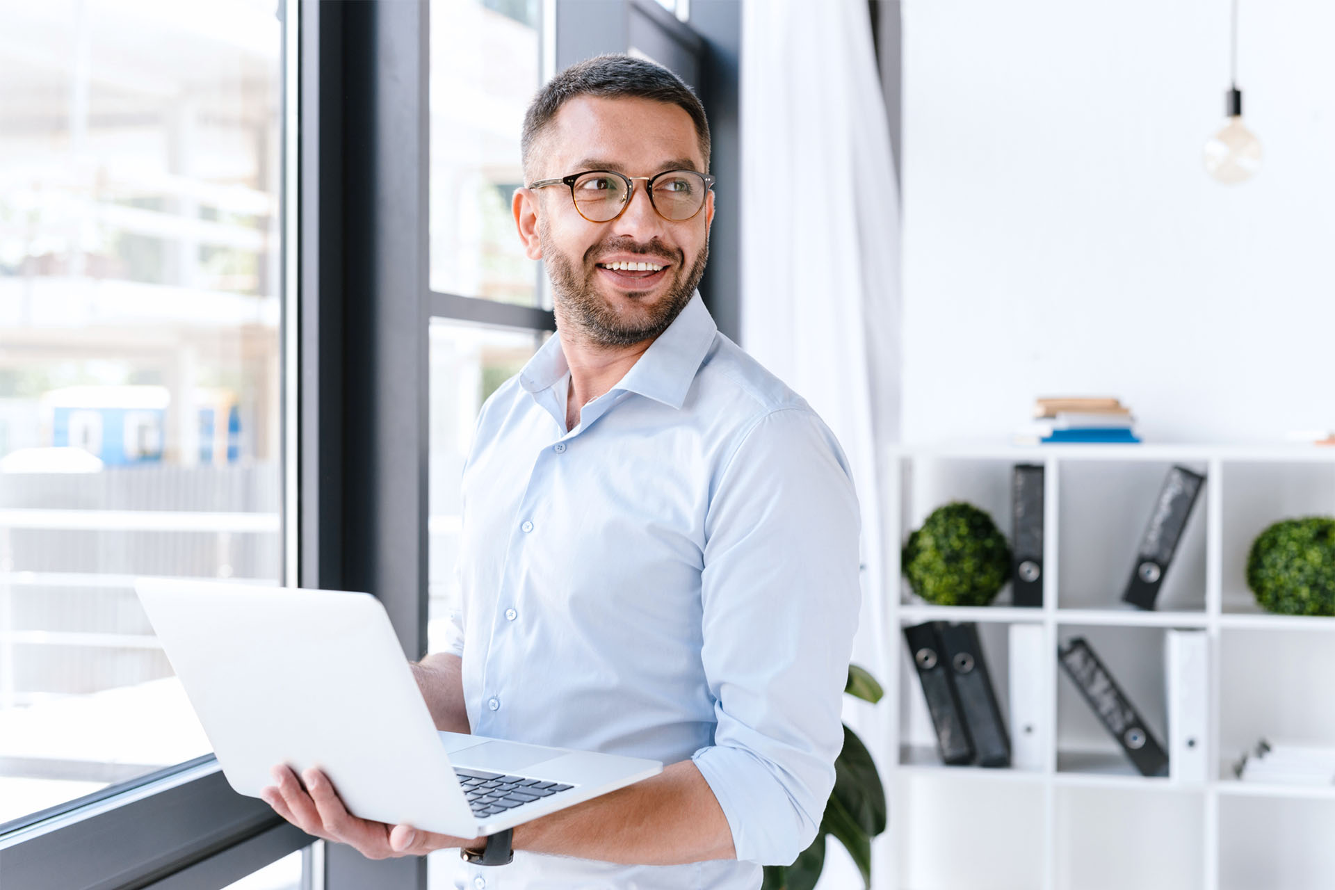 Man using laptop in a modern office.