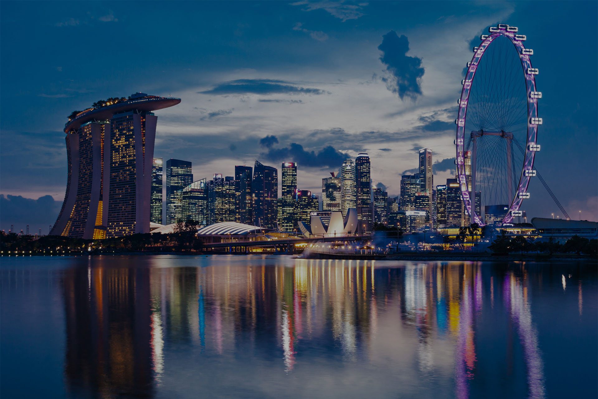 Singapore skyline at dusk, vibrant reflections. Do you need a work permit for Singapore?